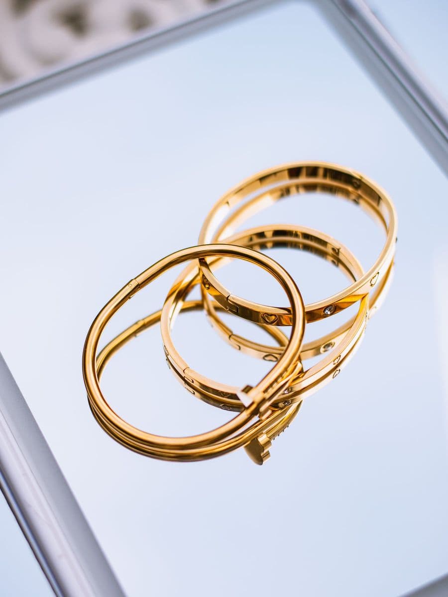 Gold bangles on a light background