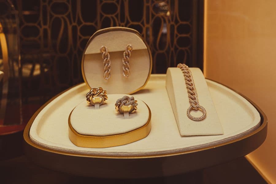 Gold earrings and a bracelet in a display case