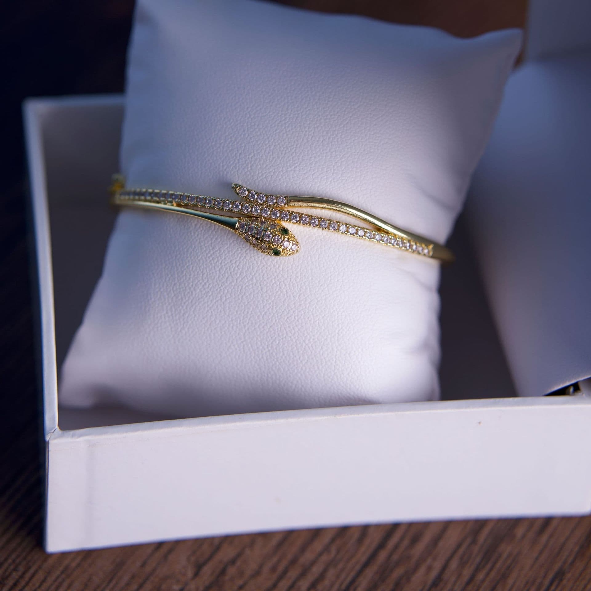 A gold serpent bracelet in a gift box