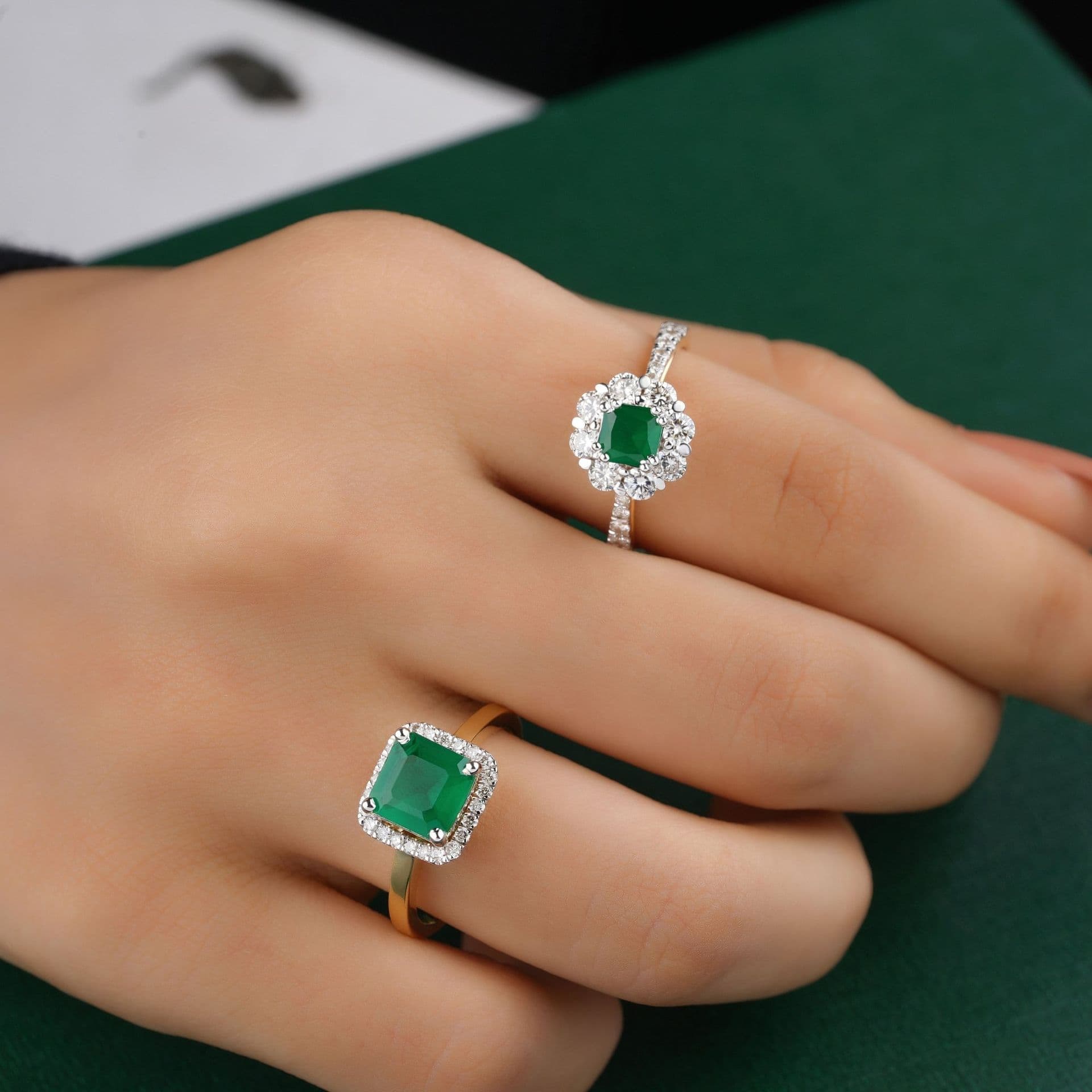 An emerald ring on a hand