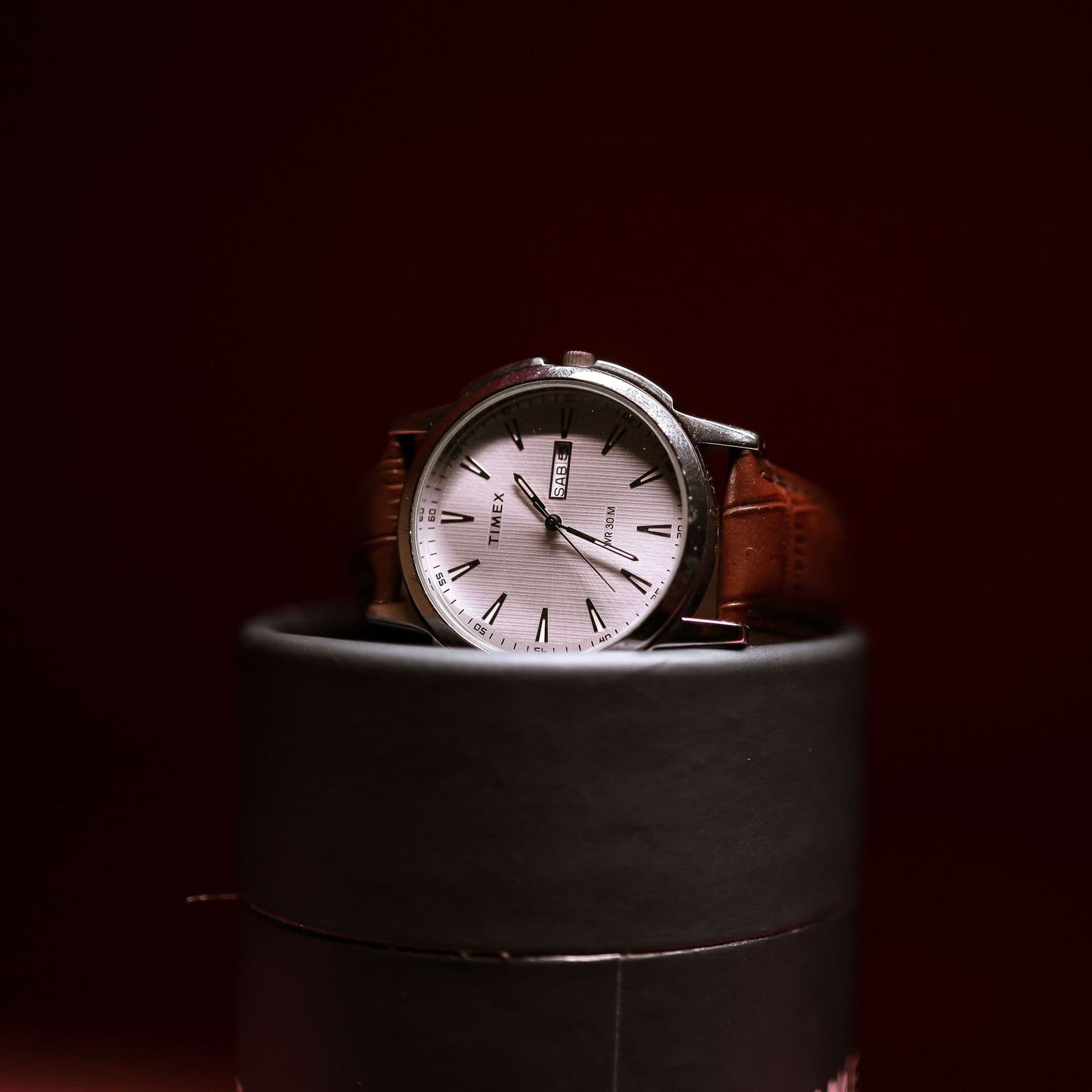A women's watch with a pink dial