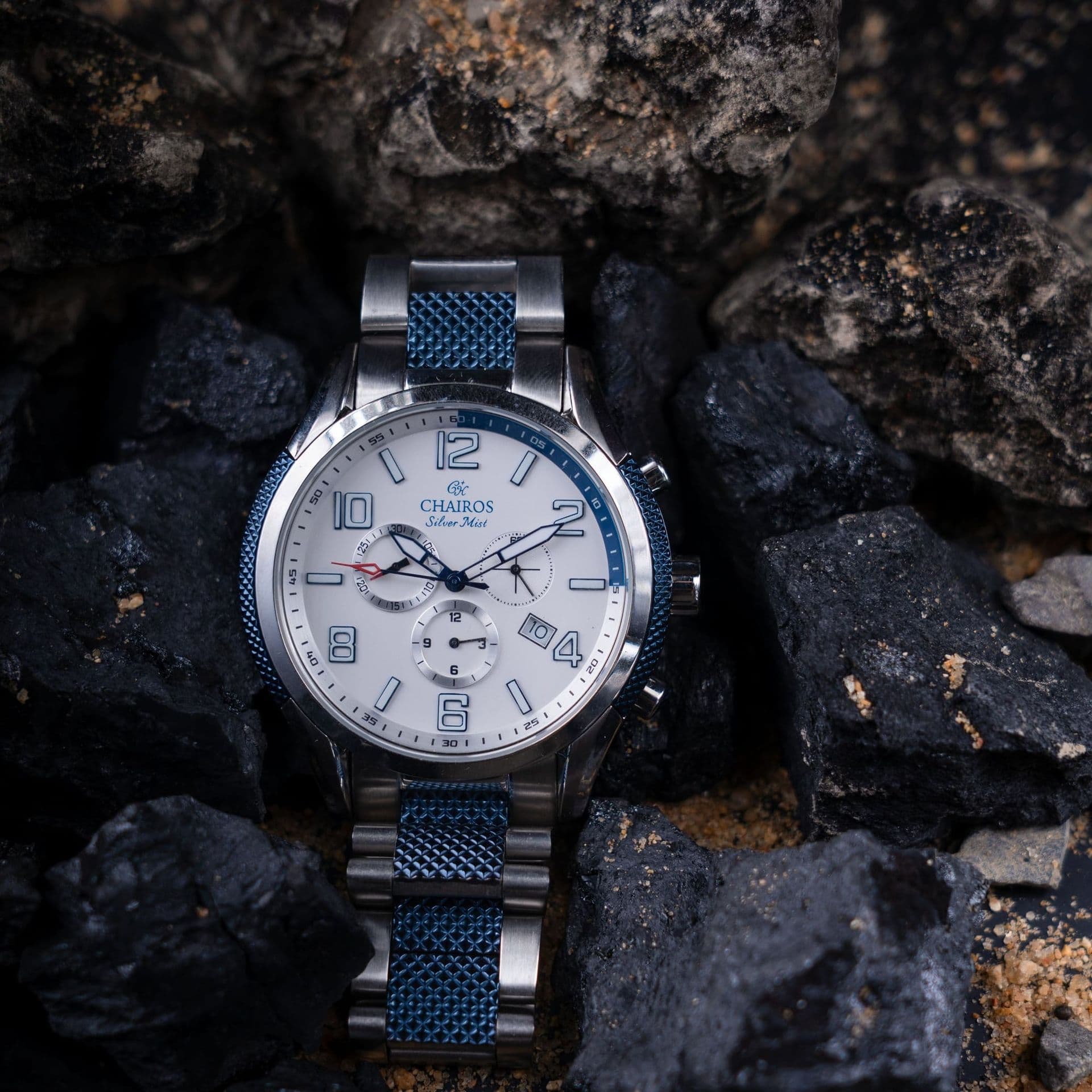 A sports watch with a white dial
