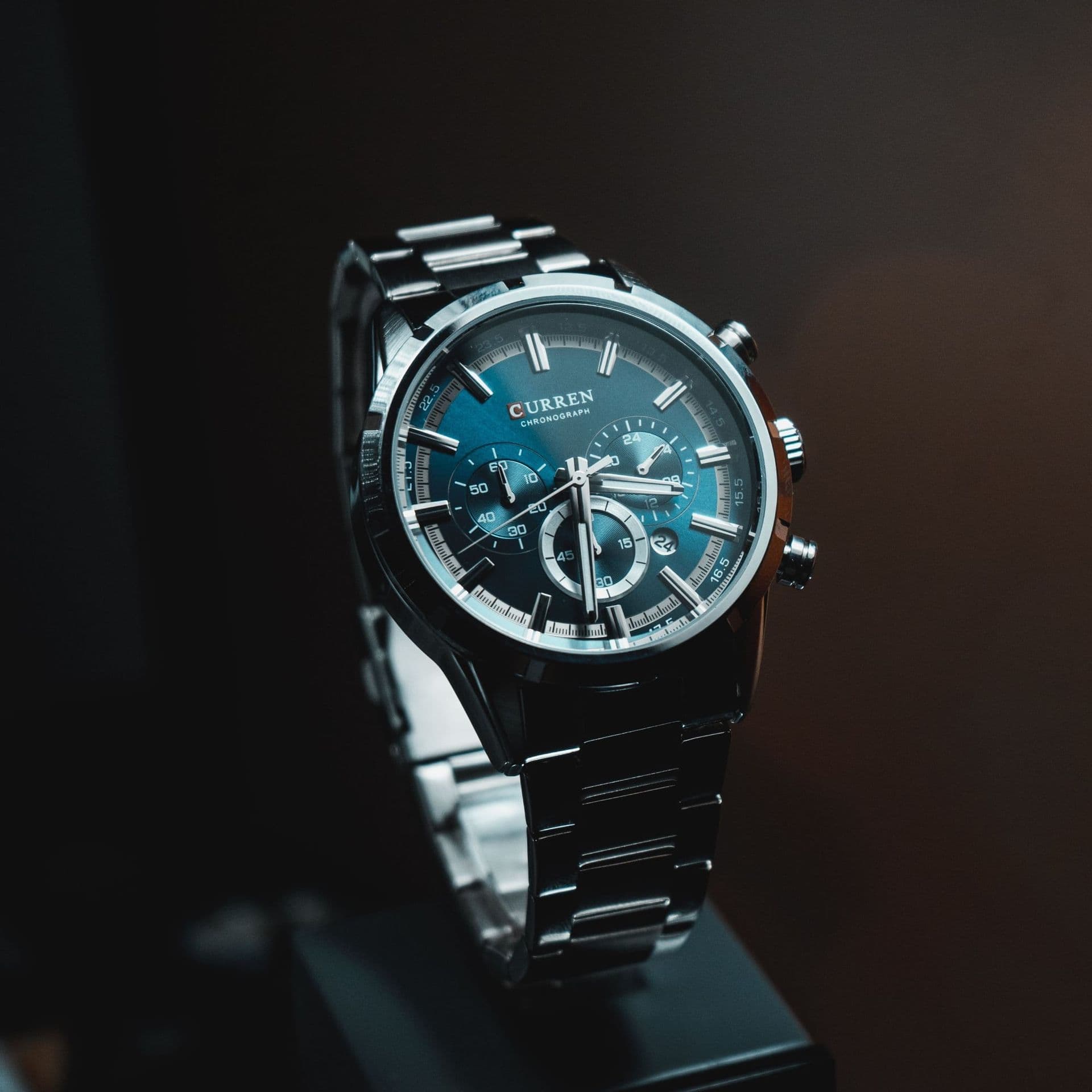 A steel watch with a blue dial