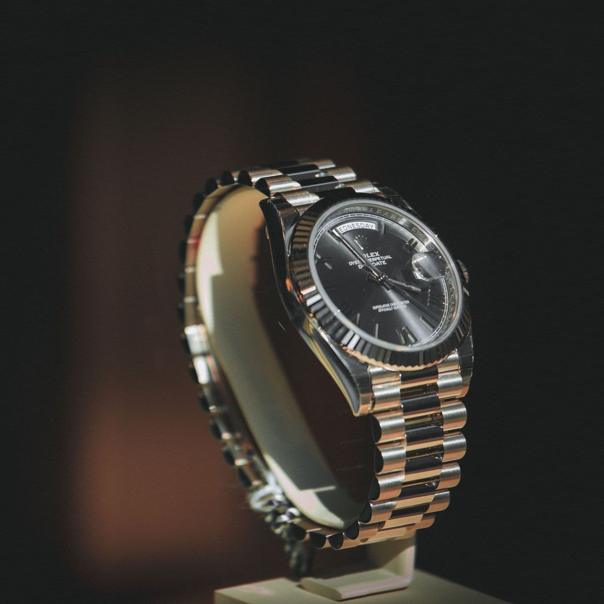 A two-tone automatic watch with a black dial